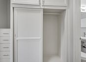 Thumbnail 48 of 49 - A white cabinet with a door is open.