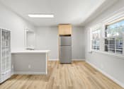 Thumbnail 41 of 49 - A kitchen with a refrigerator, a sink, and a window.