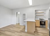 Thumbnail 36 of 49 - A kitchen with a white countertop and wooden floors.