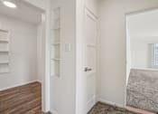 Thumbnail 28 of 40 - A white door is in the middle of a room with a grey carpet.