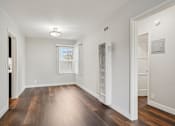 Thumbnail 28 of 64 - A room with wooden floors and white walls.