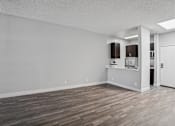 Thumbnail 30 of 53 - A room with wooden flooring and white walls.