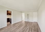 Thumbnail 24 of 51 - A room with wooden flooring and white walls.