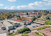 Thumbnail 44 of 51 - A view of a parking lot with cars and buildings.