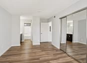 Thumbnail 41 of 59 - A room with wooden floors and white walls.