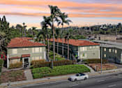 Thumbnail 50 of 51 - A white car is parked on the side of a street in front of a building.