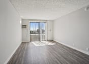 Thumbnail 42 of 53 - A room with a sliding glass door leading to a balcony.