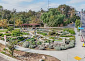 Thumbnail 37 of 51 - A landscaped garden area with a no parking sign in the foreground.