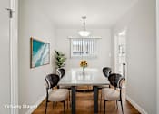 Thumbnail 3 of 40 - A dining room with a table and chairs.