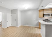 Thumbnail 19 of 30 - A kitchen with a microwave above the counter.