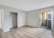 Thumbnail 13 of 35 - A room with a wooden floor and white walls.