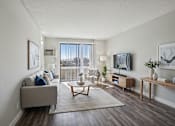 Thumbnail 1 of 53 - A living room with a grey couch and a coffee table.