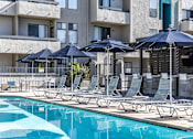 Thumbnail 32 of 54 - a pool with lounge chairs and umbrellas at a hotel