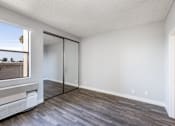 Thumbnail 42 of 54 - an empty living room with wood flooring and a window