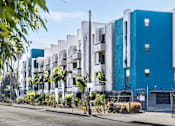Thumbnail 5 of 54 - a blue and white apartment building on a city street