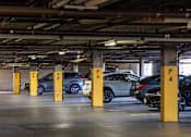 Thumbnail 44 of 54 - a parking garage with cars parked in it