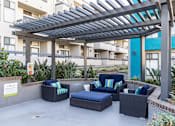 Thumbnail 31 of 54 - a patio with couches and chairs under awning