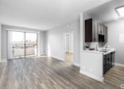 Thumbnail 41 of 54 - an open living room and kitchen with a sliding glass door to a balcony