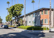 Thumbnail 28 of 37 - A street view of a residential area with cars parked on the side of the road.