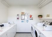 Thumbnail 35 of 37 - A laundromat with washers and dryers and a sign that says