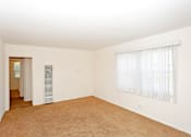 Thumbnail 9 of 47 - A room with a window covered by white blinds.