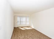 Thumbnail 27 of 47 - A room with white walls and a carpeted floor.