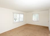 Thumbnail 28 of 47 - A large empty room with two windows.
