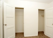 Thumbnail 34 of 47 - A white door is open to a hallway.