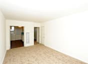 Thumbnail 33 of 47 - A room with a carpeted floor and white walls.