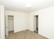 Thumbnail 43 of 47 - A white room with carpeted floor and two doors.