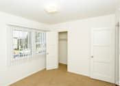 Thumbnail 47 of 47 - A white room with a window and a door.