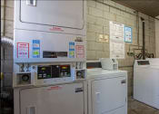 Thumbnail 16 of 20 - a laundry room with two washing machines and washers