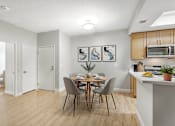 Thumbnail 5 of 30 - A kitchen with a dining table and chairs.