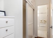Thumbnail 18 of 30 - A white drawer with a silver handle sits next to a white door.