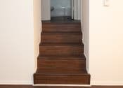 Thumbnail 4 of 21 - a staircase in a home with wood floors and white walls