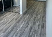 Thumbnail 10 of 54 - an empty kitchen and living room with wood flooring
