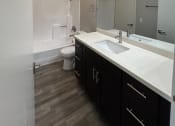 Thumbnail 25 of 54 - a bathroom with a sink and a shower and a toilet