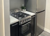 Thumbnail 27 of 54 - a kitchen with a stove and a microwave and a refrigerator