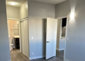 Thumbnail 26 of 54 - a renovated living room with wood flooring and a bathroom