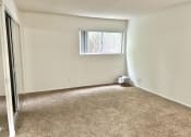 Thumbnail 6 of 21 - an empty living room with carpet and a window