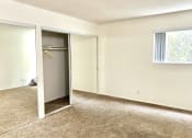 Thumbnail 30 of 31 - an empty room with a mirror and a closet
