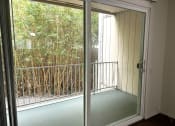 Thumbnail 31 of 31 - a room with a balcony and a sliding glass door
