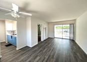 Thumbnail 1 of 30 - A room with a ceiling fan and sliding glass doors.