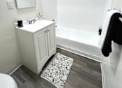 Thumbnail 6 of 30 - A white bathroom with a toilet, sink, and mirror.