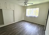 Thumbnail 2 of 30 - A room with a ceiling fan and a window with blinds.