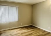 Thumbnail 10 of 40 - an empty room with a window and wooden floors