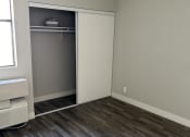 Thumbnail 14 of 54 - an empty room with a closet and wooden floors