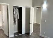 Thumbnail 11 of 54 - a renovated living room with a closet and wood flooring