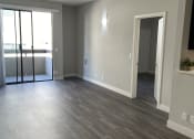Thumbnail 13 of 54 - an empty living room with wood flooring and a balcony