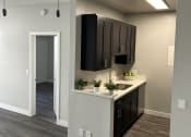 Thumbnail 12 of 54 - a kitchen with black cabinets and a white counter top